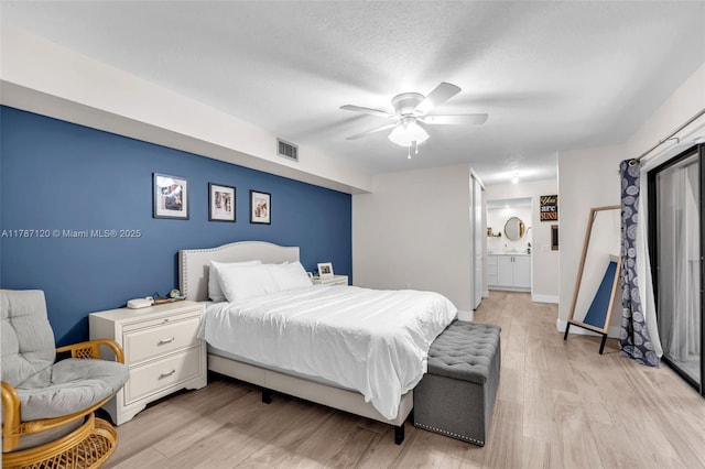 9153 SW 23rd St Unit D, Davie, FL 33324 - bedroom featuring connected bathroom, a ceiling fan, light wood finished floors, and visible vents
