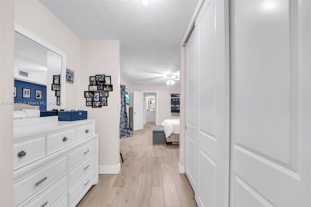 9153 SW 23rd St Unit D, Davie, FL 33324 - corridor featuring a textured ceiling, visible vents, baseboards, and light wood-style floors