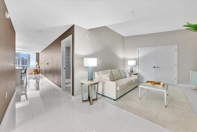 living room with baseboards and light tile patterned floors