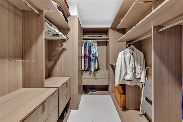 spacious closet featuring light tile patterned flooring