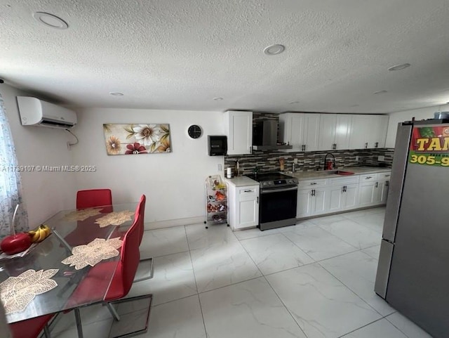 kitchen with freestanding refrigerator, a wall mounted air conditioner, black electric range oven, marble finish floor, and light countertops
