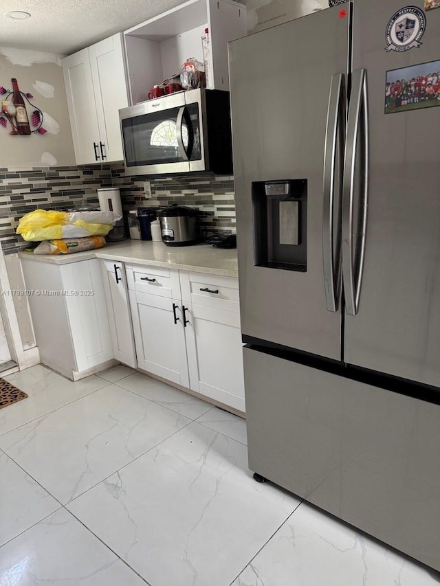 kitchen with stainless steel appliances, white cabinetry, decorative backsplash, marble finish floor, and open shelves