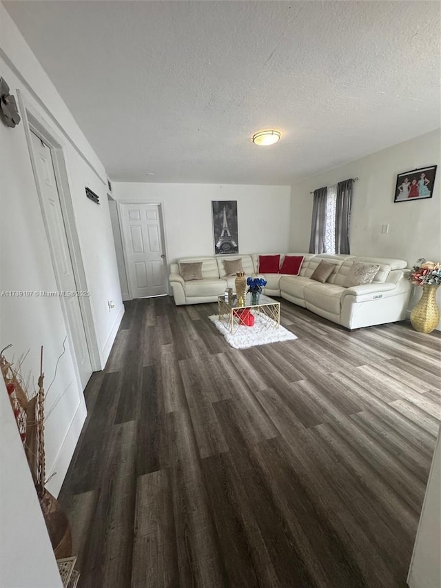 living room with wood finished floors and a textured ceiling