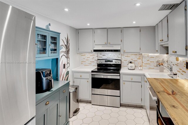100 Bayview Unit 617, Sunny Isles Beach, FL 33160 - kitchen featuring stainless steel appliances, ventilation hood, light tile patterned flooring, recessed lighting, and gray cabinets