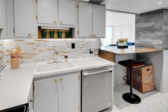 100 Bayview Unit 617, Sunny Isles Beach, FL 33160 - kitchen featuring dishwasher, light countertops, decorative backsplash, light tile patterned flooring, and open shelves