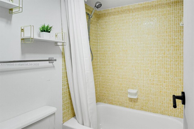 100 Bayview Unit 617, Sunny Isles Beach, FL 33160 - bathroom with shower / bathtub combination with curtain and toilet