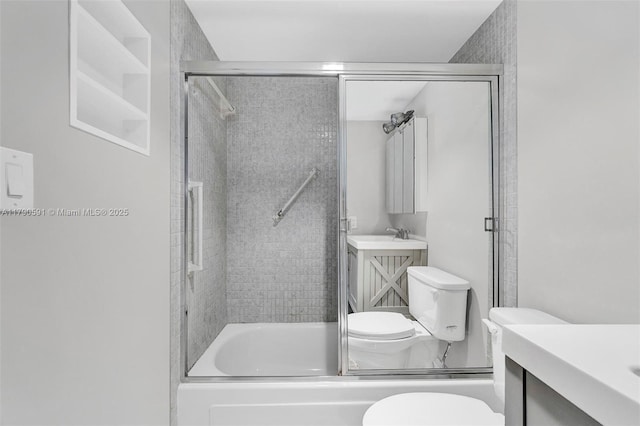 1810 New Palm Way Unit 214, Boynton Beach, FL 33435 - bathroom featuring toilet, vanity, and shower / bath combination with glass door