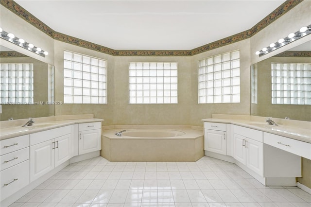 full bath featuring tile patterned floors, two vanities, and a sink
