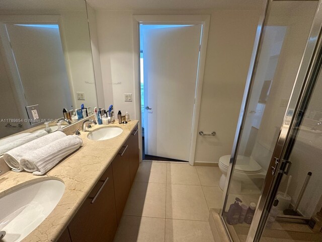 50 Biscayne Blvd Unit 3308, Miami, FL 33132 - bathroom featuring a sink, double vanity, toilet, and a stall shower