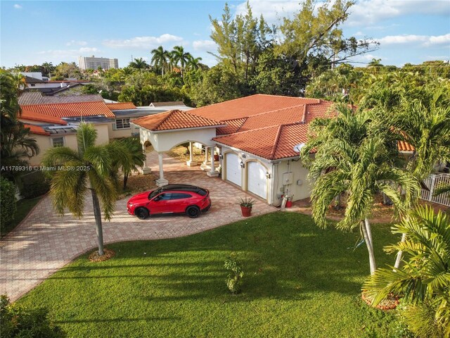 105 S Royal Poinciana Blvd, Miami Springs, FL 33166 - mediterranean / spanish-style house with a front yard, stucco siding, decorative driveway, a tiled roof, and an attached garage