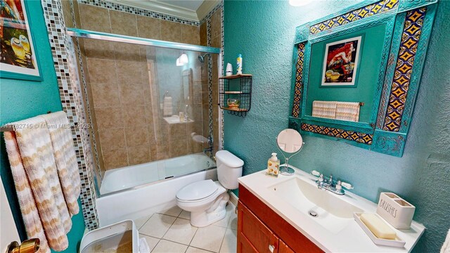 2884 SE 2nd Dr Unit 7, Homestead, FL 33033 - bathroom featuring toilet, enclosed tub / shower combo, tile patterned floors, vanity, and a textured wall