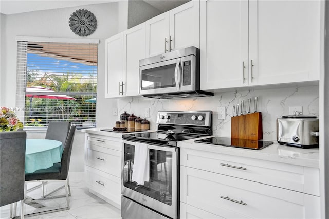 1543 NW 182nd Way, Pembroke Pines, FL 33029 - kitchen with stainless steel appliances, white cabinets, light marble finish flooring, and decorative backsplash