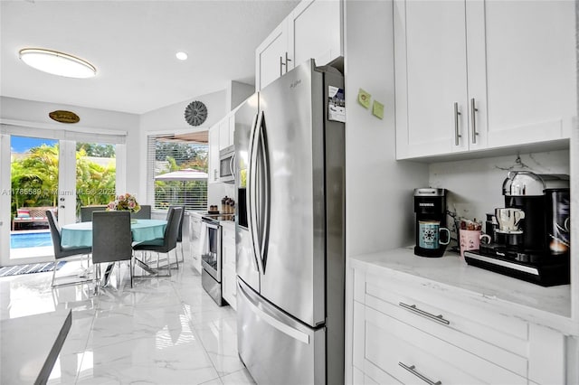 1543 NW 182nd Way, Pembroke Pines, FL 33029 - kitchen with stainless steel appliances, light marble finish flooring, white cabinetry, light stone counters, and recessed lighting