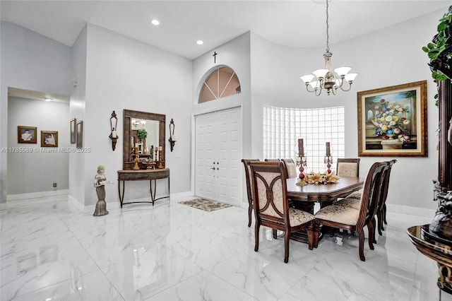 1543 NW 182nd Way, Pembroke Pines, FL 33029 - dining room featuring a chandelier, light marble finish flooring, a high ceiling, and recessed lighting