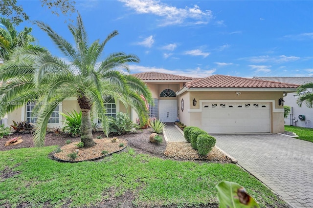 1543 NW 182nd Way, Pembroke Pines, FL 33029 - mediterranean / spanish-style house with stucco siding, a garage, decorative driveway, and a tile roof