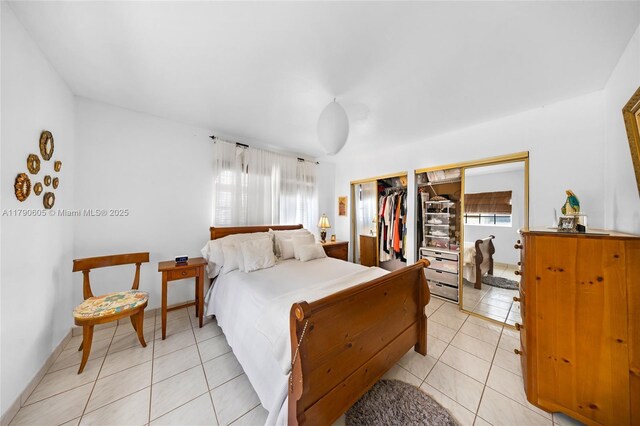 16823 SW 113th Ave Unit V41342, Miami, FL 33157 - bedroom featuring multiple closets, light tile patterned floors, and multiple windows