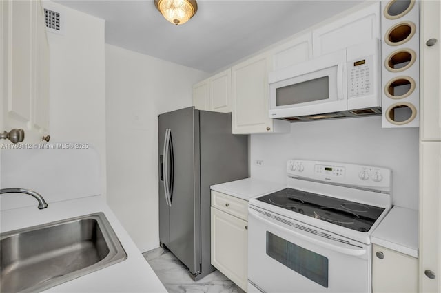 kitchen featuring a sink, visible vents, light countertops, white appliances, and marble finish floor