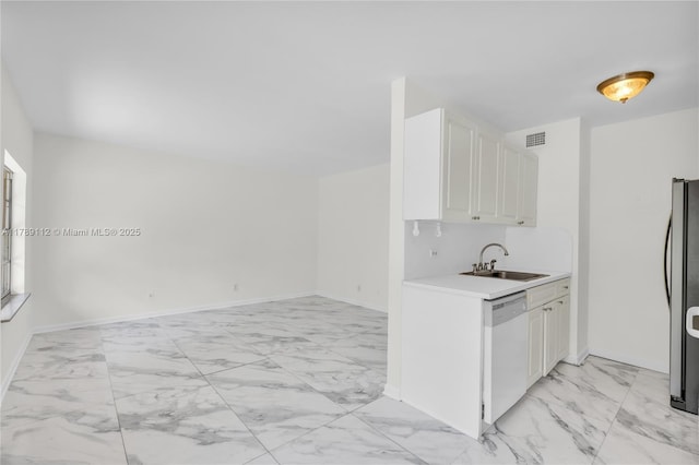 kitchen with a sink, marble finish floor, visible vents, light countertops, and dishwasher