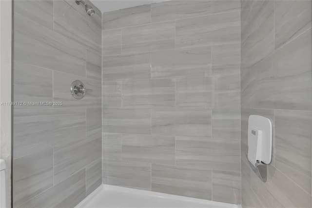 full bath featuring tiled shower