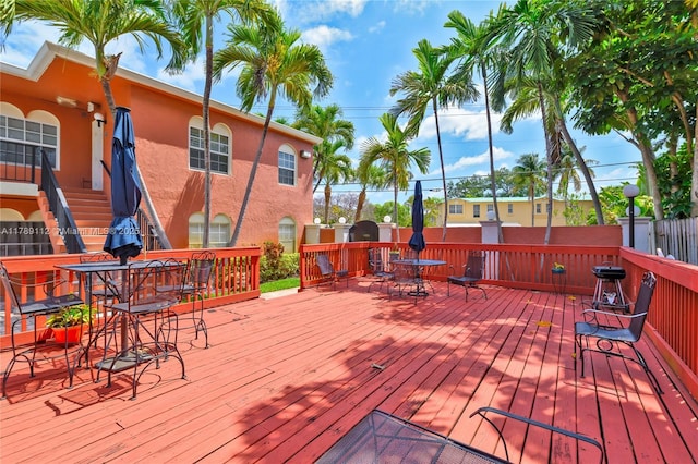 wooden deck featuring outdoor dining area
