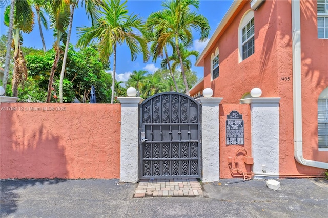 view of gate with a fenced front yard