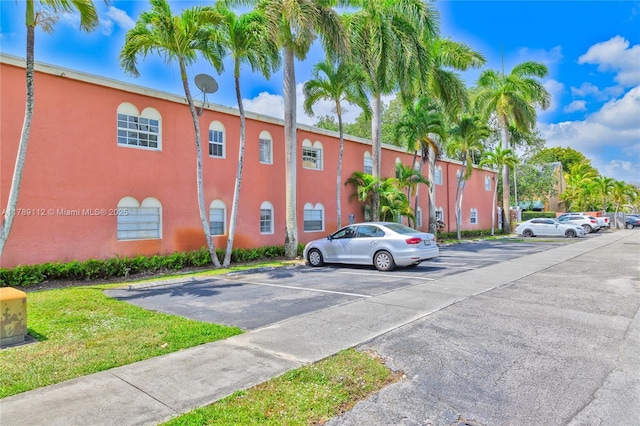 view of property featuring uncovered parking