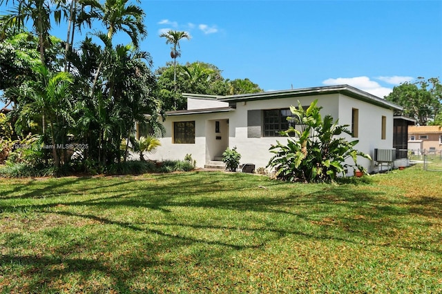 single story home featuring stucco siding and a front lawn