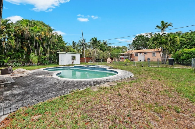 view of pool featuring a storage shed, an outdoor structure, a fenced backyard, and a lawn