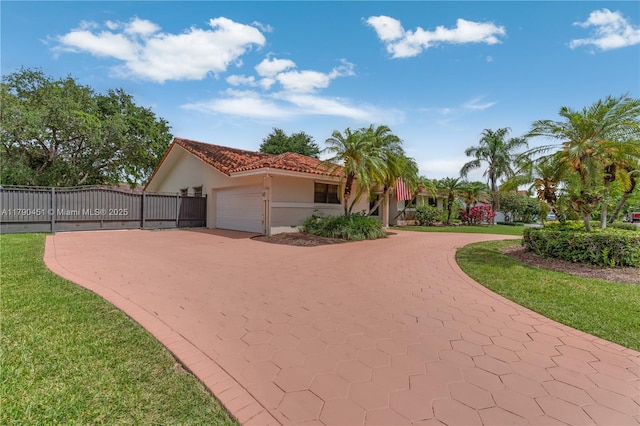 view of front facade featuring stucco siding, a gate, fence, a garage, and curved driveway