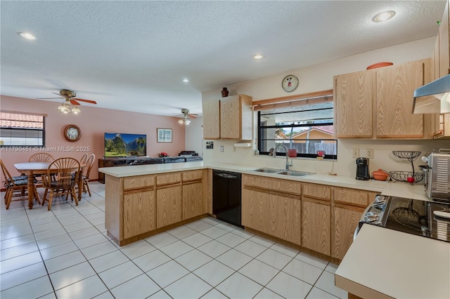 kitchen with black dishwasher, light countertops, ceiling fan, a sink, and a peninsula