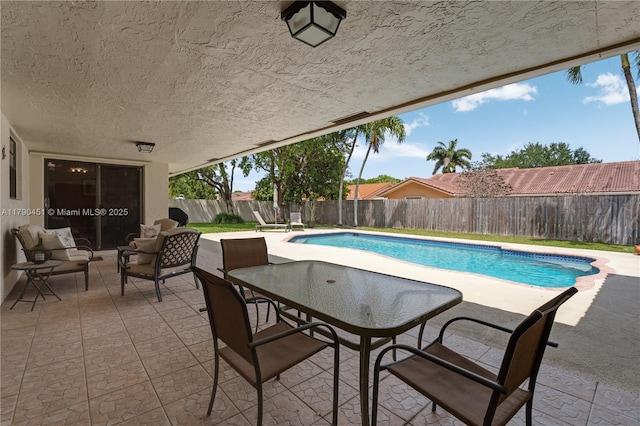view of swimming pool featuring a patio, a fenced in pool, and a fenced backyard