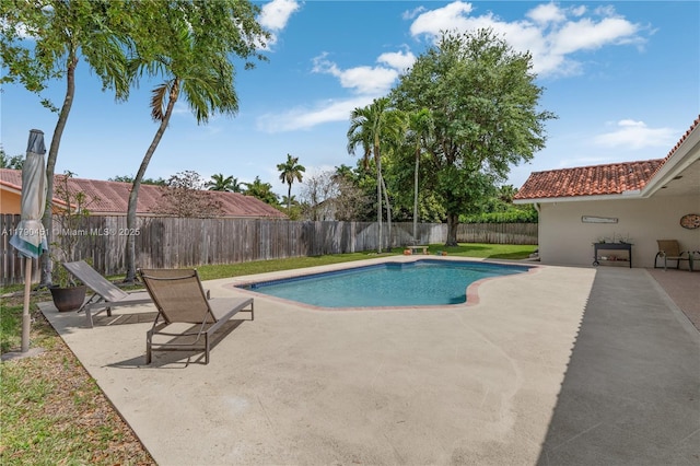 view of swimming pool with a fenced backyard, a patio, and a fenced in pool