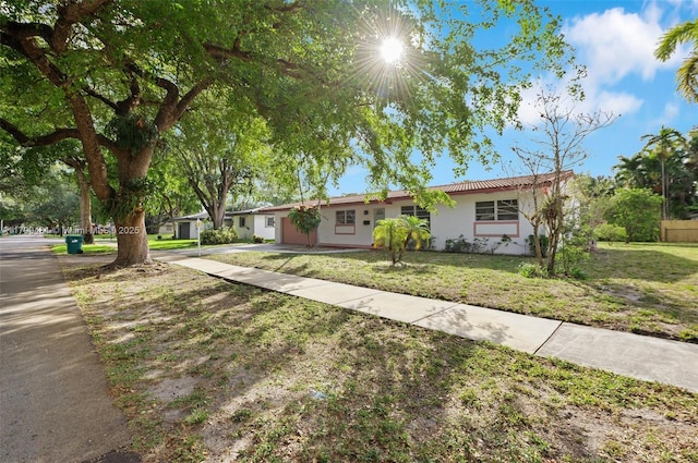 14515 Mahogany Ct, Miami Lakes, FL 33014 - ranch-style home featuring concrete driveway, an attached garage, a front lawn, and stucco siding