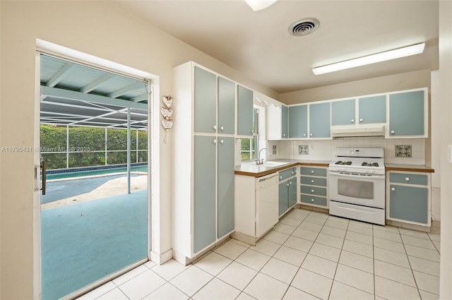 14515 Mahogany Ct, Miami Lakes, FL 33014 - kitchen with visible vents, white appliances, under cabinet range hood, tasteful backsplash, and a sink