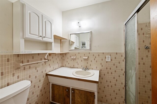 14515 Mahogany Ct, Miami Lakes, FL 33014 - full bath with wainscoting, vanity, toilet, tile walls, and a stall shower