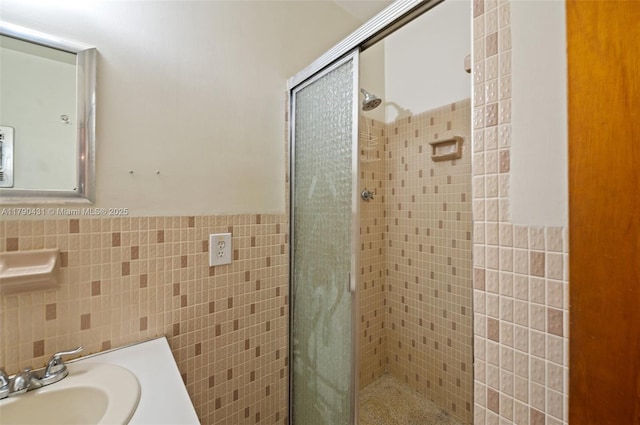 14515 Mahogany Ct, Miami Lakes, FL 33014 - bathroom featuring tile walls, wainscoting, a sink, and a stall shower