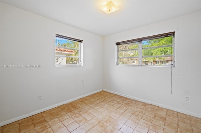 14515 Mahogany Ct, Miami Lakes, FL 33014 - spare room with light tile patterned floors, baseboards, and a wealth of natural light
