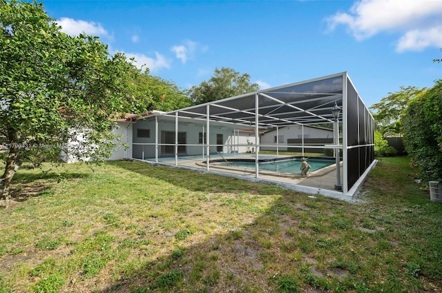 14515 Mahogany Ct, Miami Lakes, FL 33014 - rear view of property with glass enclosure, a patio, a yard, and an outdoor pool