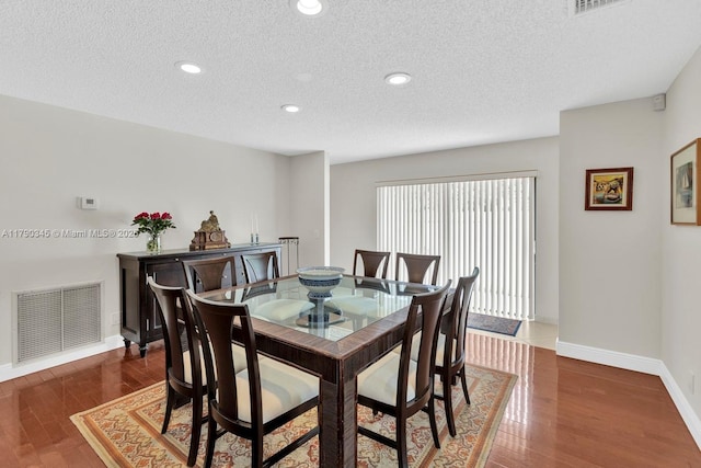 1800 NW 105th Ln, Coral Springs, FL 33071 - dining area with baseboards, visible vents, wood finished floors, and a textured ceiling