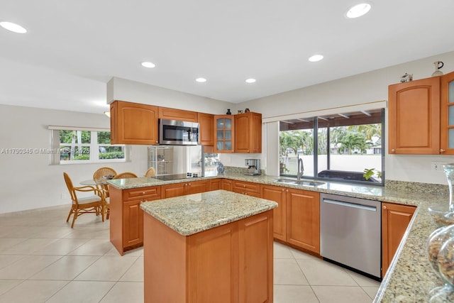 1800 NW 105th Ln, Coral Springs, FL 33071 - kitchen featuring light stone countertops, a sink, light tile patterned floors, a center island, and appliances with stainless steel finishes