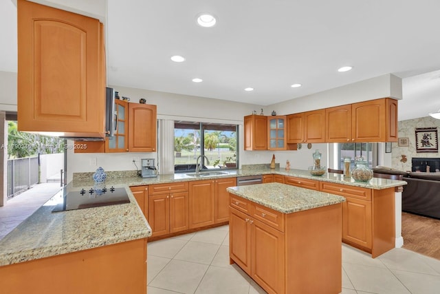 1800 NW 105th Ln, Coral Springs, FL 33071 - kitchen featuring light stone counters, black electric cooktop, glass insert cabinets, and a sink