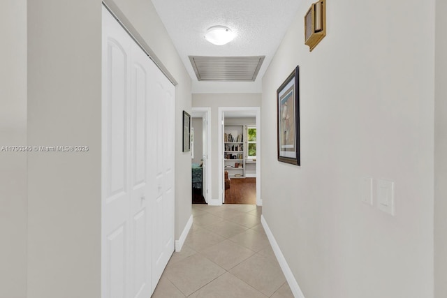 1800 NW 105th Ln, Coral Springs, FL 33071 - corridor with light tile patterned floors, visible vents, a textured ceiling, and baseboards