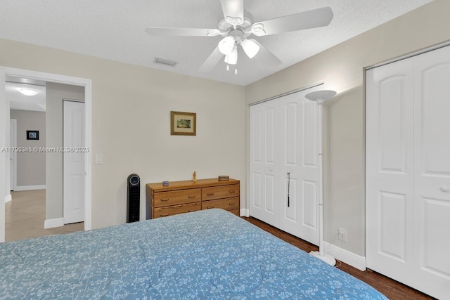 1800 NW 105th Ln, Coral Springs, FL 33071 - bedroom featuring multiple closets, ceiling fan, baseboards, visible vents, and a textured ceiling