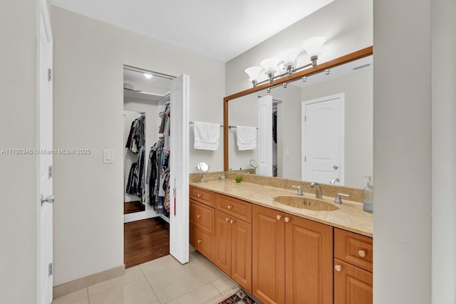 1800 NW 105th Ln, Coral Springs, FL 33071 - bathroom featuring vanity, baseboards, tile patterned flooring, and a walk in closet