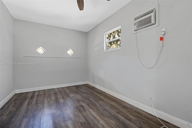 1185 Biarritz Dr, Miami Beach, FL 33141 - spare room featuring an AC wall unit, baseboards, ceiling fan, and dark wood-style floors