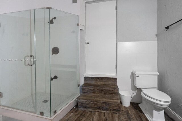 1185 Biarritz Dr, Miami Beach, FL 33141 - bathroom featuring a shower stall, toilet, and wood finished floors