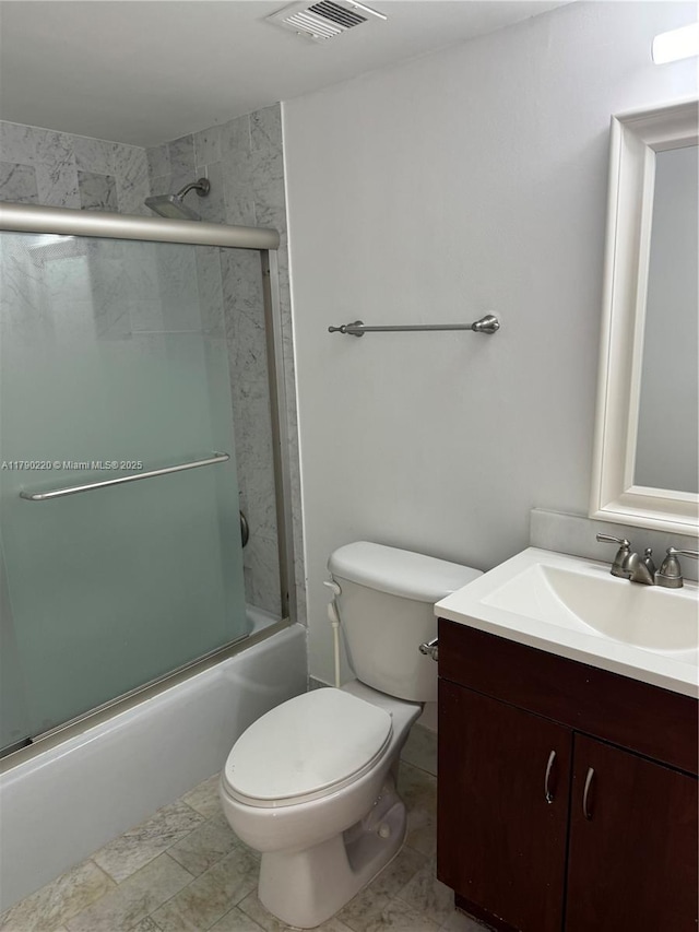 1420 Brickell Bay Dr Unit 103A1, Miami, FL 33131 - full bathroom with shower / bath combination with glass door, toilet, visible vents, and vanity