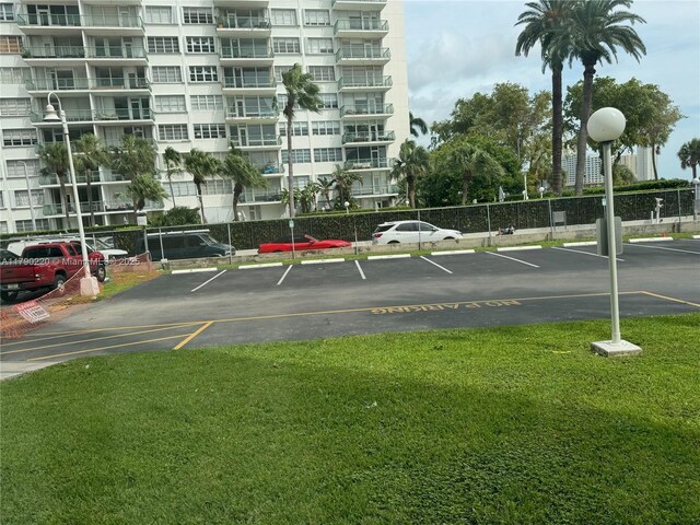 1420 Brickell Bay Dr Unit 103A1, Miami, FL 33131 - uncovered parking lot featuring fence