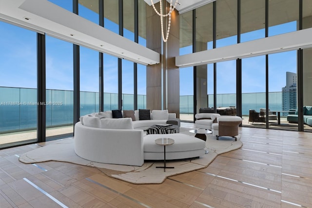 living room with expansive windows and a towering ceiling