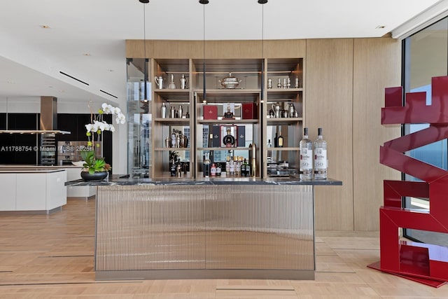 bar with a bar and wood finished floors